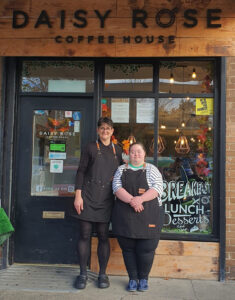 Lucy and her employer standing proudly outside the Daisy Rose Coffee House in Durham.