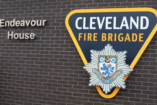 The side of the building with the Cleveland Fire Brigade logo. Signage reads Endeavor House.
