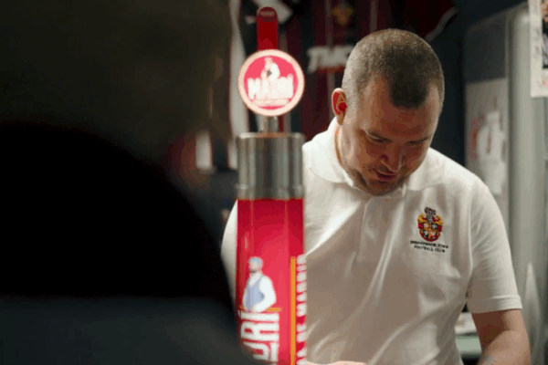 Aaron, employee at Spennymoor Town FC, working behind the bar.