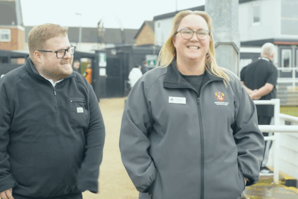 Rob and his employer smiling outside of Spennymoor Town FC